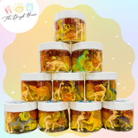 Dino-themed sensory dough jar with toy dinosaurs and trinkets