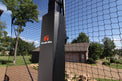Goalrilla basketball goal in a backyard with trees and house in the background