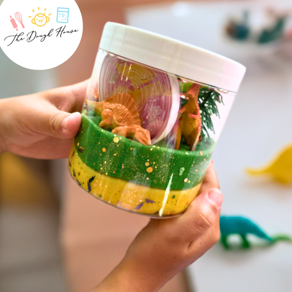 Dinosaur sensory dough jar with red, orange, and yellow dough